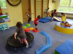 mehrere Kinder turnen im Sportraum