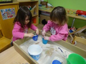 2 Mädchen spielen mit Reis